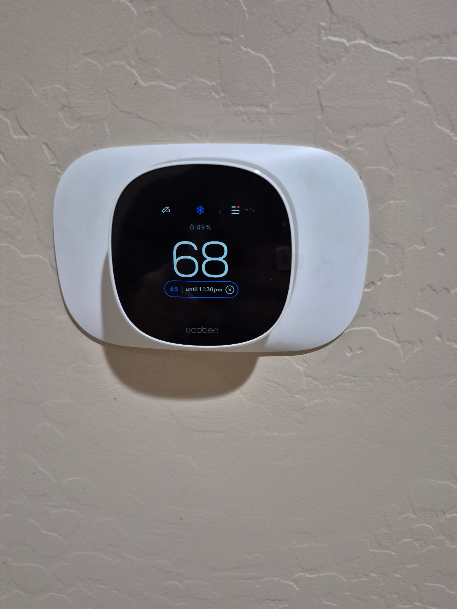 Smart thermostat showing temperature and humidity
